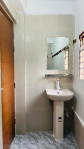 a bathroom with a sink and a mirror at Hotel New Kalabagan in Dhaka