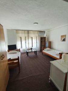 a large room with two beds and a table at Natasa in Bačka Palanka