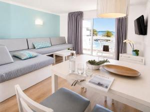 a living room with a couch and a table at Cabot Sivella Apartments in Port de Pollensa