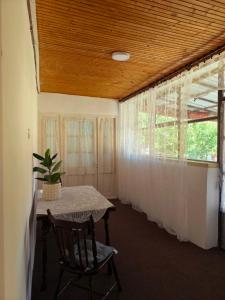 a dining room with a table and a window at Natasa in Bačka Palanka