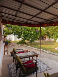a patio with a table and chairs under a pergola at Natasa in Bačka Palanka