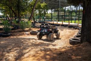 a four wheeler parked in a park with tires at Family Hotel Adria - All inclusive in Biograd na Moru