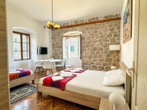 a bedroom with a bed and a table with chairs at LaRos Apt in Herceg-Novi +285 photos