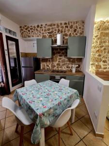 a table and chairs in a kitchen with a table and a tablecloth at Cavour 92 in Alatri