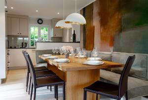 a dining room with a wooden table and chairs at LITZKOW 14205 in Morsum