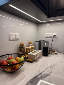 a room with a bowl of fruit on a counter at City Vibes Corinth in Korinthos