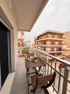 a balcony with a table and chairs on a balcony at City Vibes Corinth in Korinthos