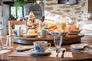 a table with a tray of pastries and coffee cups at Ecrin du Ségala - Chambres d'hôtes in Tauriac-de-Naucelle +5 photos
