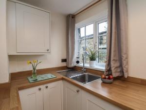a kitchen with a sink and a window at 4 Lilac Cottages in Whitby