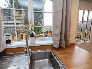 a kitchen with a sink and a window at 4 Lilac Cottages in Whitby +30 photos