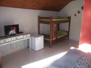 a room with two bunk beds and a television at Rancho Pôr Do Sol in Arapeí +53 photos