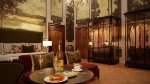 a room with a bed and a table with food on it at Eight Venezia in Venice
