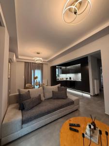 a living room with a couch and a table at City Vibes Corinth in Korinthos