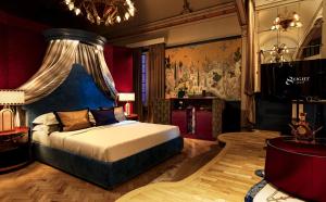 a bedroom with a king sized bed with a blue headboard at Eight Venezia in Venice
