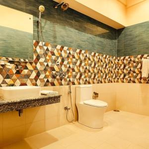 a bathroom with a toilet and a sink at The kempty Fall Resort, Mussoorie - Lavish & Luxury Stay in Mussoorie +33 photos