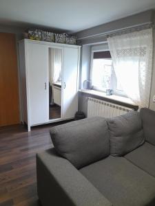 a living room with a couch and a window at Malwers in Zielonka