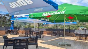 a group of tables and chairs with umbrellas at hotel G&G in Tsaghveri +2 photos