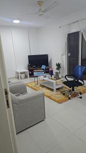 a living room with a couch and a table at RelaxAlkhuwirHostel in Muscat