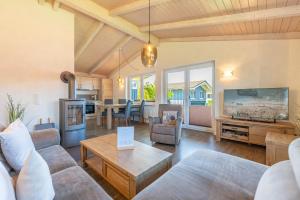 a living room with a couch and a table at Ferienhaus Süderoog in Dagebüll
