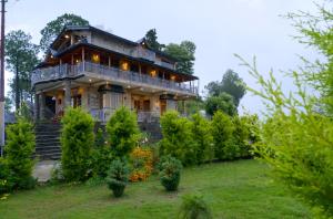 a large house on a hill with a garden at Pine Grey Castle in Almora +42 photos