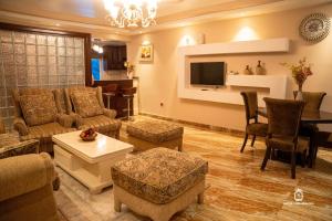 a living room with a couch and a table at Hotel Lubumbashi Golf in Lubumbashi