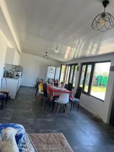 a room with a table and chairs and a kitchen at Casa Rodica in Mangalia +16 photos