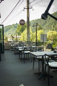 a row of tables and chairs on a deck at Casa Braneana in Bran