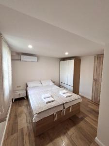 a bedroom with a bed with two towels on it at Your Cozy Home 2BR Local Vibe 25 Mins to Center in Yerevan +10 photos