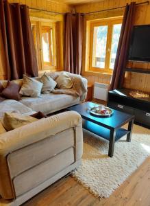 a living room with a couch and a coffee table at La Tapia in La Foux d'Allos