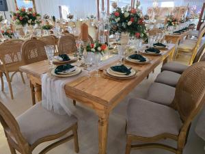 a long wooden table with plates and wine glasses at Sunrise Serenity Guest House in Lydenburg