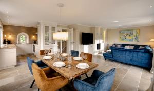a dining room and living room with a table and chairs at Litzkow 11205 in Morsum