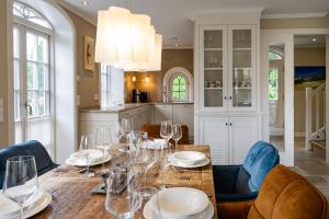 a dining room with a table with wine glasses at Litzkow 11205 in Morsum +11 photos
