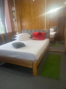 a bed with two pillows on it in a room at The Rainbow Inn in Sonāda