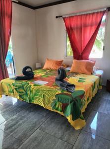 a bedroom with a bed with a colorful comforter at Terai vahine lodge in Rangiroa
