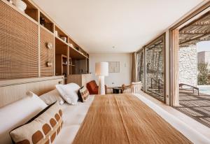 a bedroom with a bed and a large window at Le Mirage in Bormes-les-Mimosas +207 photos