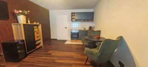 a living room with a table and chairs and a kitchen at Pension Sonne in Baden-Baden +33 photos
