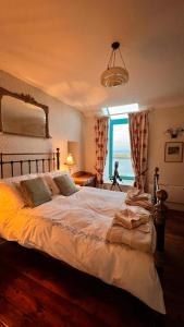 a bedroom with a large bed with a view of the ocean at The Point by the Sea in Carraroe