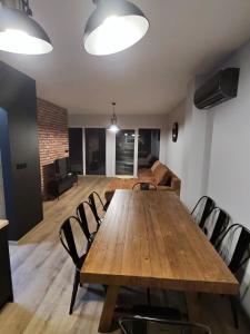 a living room with a wooden table and chairs at Black House in Sława