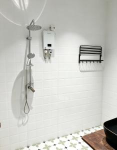 a bathroom with a shower with a toilet and a sink at Tea time B&B 叙茶时光客栈 in Luang Prabang