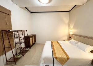 a hotel room with a bed and a ladder at Tea time B&B 叙茶时光客栈 in Luang Prabang +25 photos