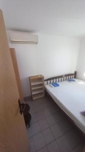 a small room with two beds and a cabinet at Nikola CG in Sutomore