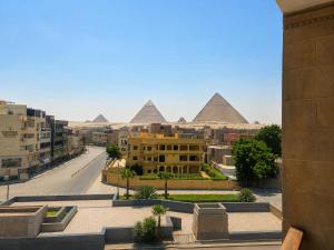 a view of the pyramids from the city of cairo at Flower Pyramids Inn in Cairo
