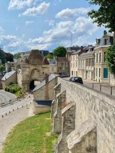 a view of a city with a stone wall at Logis de l'Éperon Laon in Laon