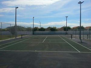 a tennis court with two tennis nets on it at Caribbean Estate AJ in Portmore