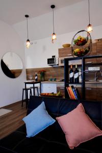 a living room with a couch with two pillows at Odavagyok Vendégház in DiÃ³sviszlÃ³