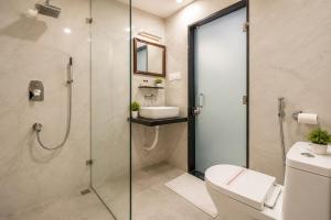 a bathroom with a shower and a toilet and a sink at Ashish Palace - A City Centre Hotel in Udaipur +25 photos