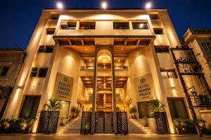 a building with stairs in front of it at night at Ashish Palace - A City Centre Hotel in Udaipur