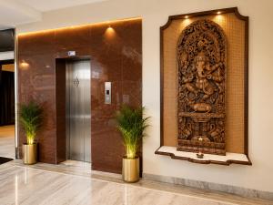 an entrance to a lobby with a large wooden door at Ashish Palace - A City Centre Hotel in Udaipur