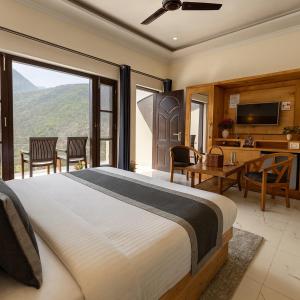 a bedroom with a large bed with a large window at The Four Season Resort, Mussoorie - top rated & most awarded property in mussoorie in Mussoorie