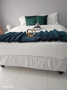 a bed with two gold wedding rings on it at Green Harvest BnB in Newmansford
